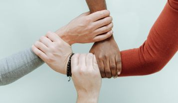 HOLDING HAND SYMBOL OF COOPERATION